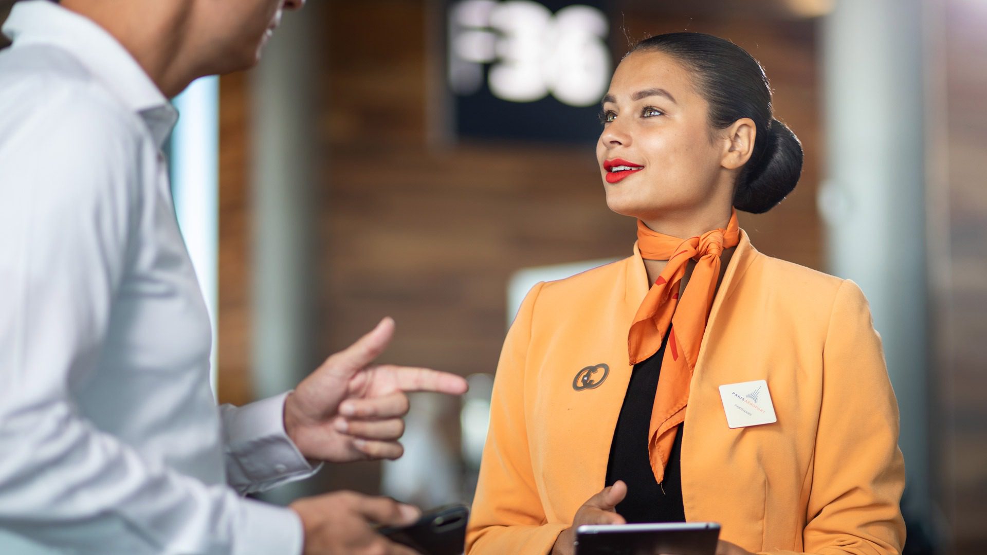 Une femme parle à un homme dans un aéroport en attendant son vol.